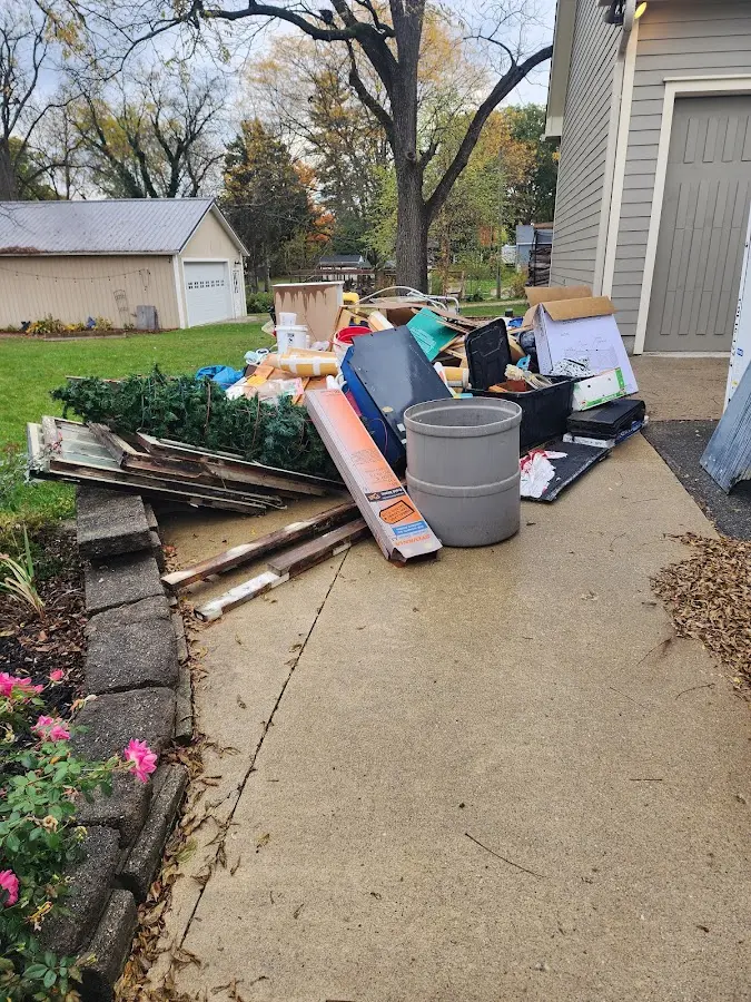 Dumpster being loaded with debris for Estate Cleanout Dumpster Rental in Bryan